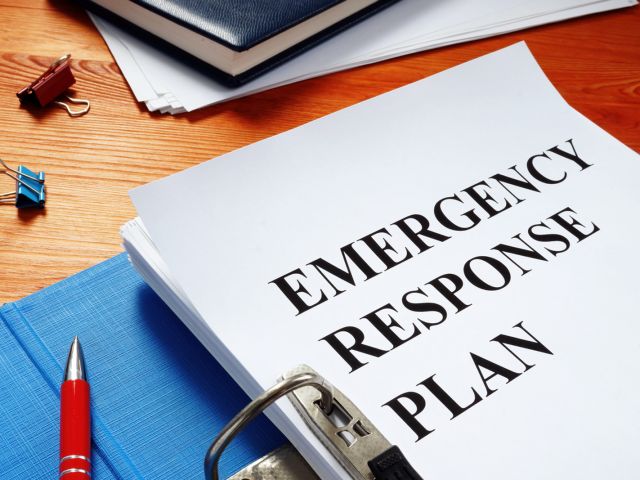 An open notebook shows off a school's emergency response plan