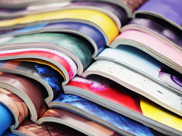 A stack of opened magazines
