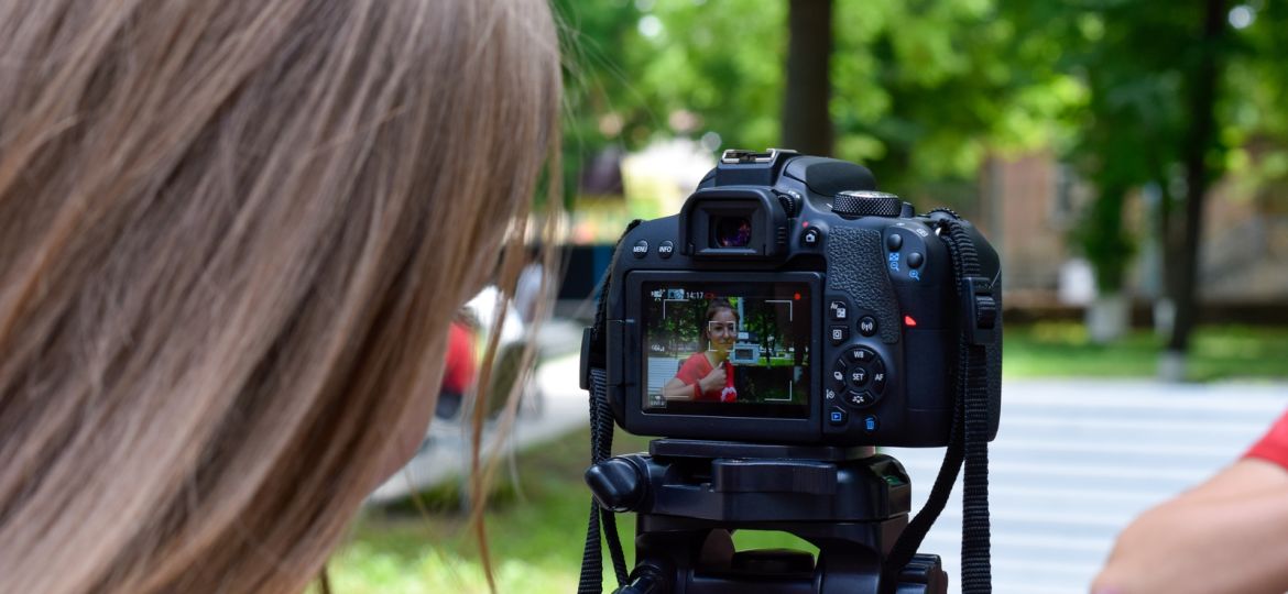 Young photographer takes an image at school