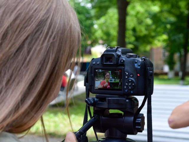 Young photographer takes an image at school